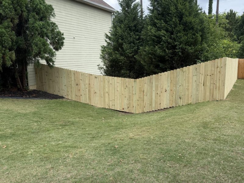 Newly installed wood privacy fence with vertical boards enclosing a residential backyard in the CSRA.