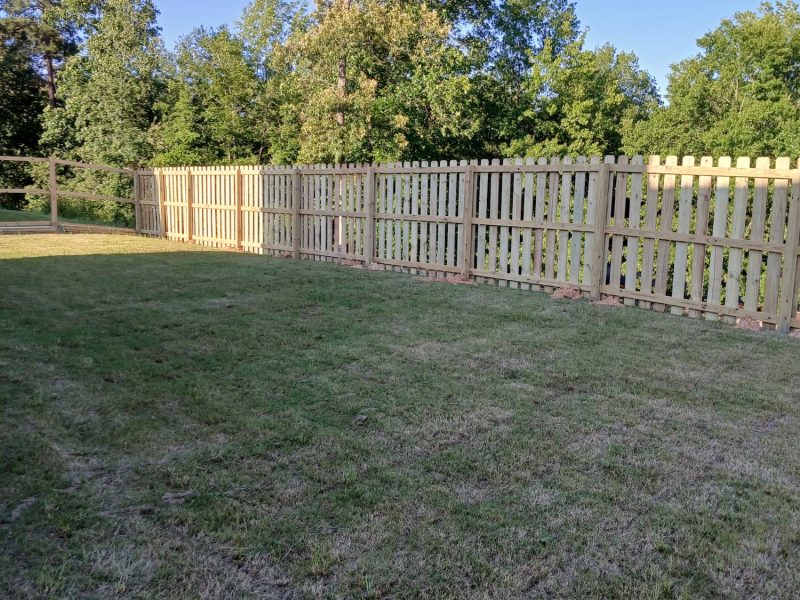 White wood picket fence with vertical slats enclosing residential backyard in rural CSRA setting.
